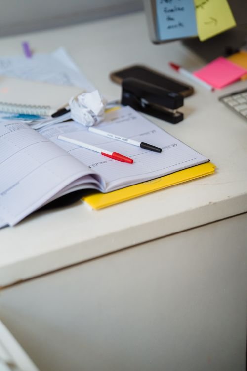 Organized desk with a planner, pens, and office supplies, representing a faculty productivity workspace